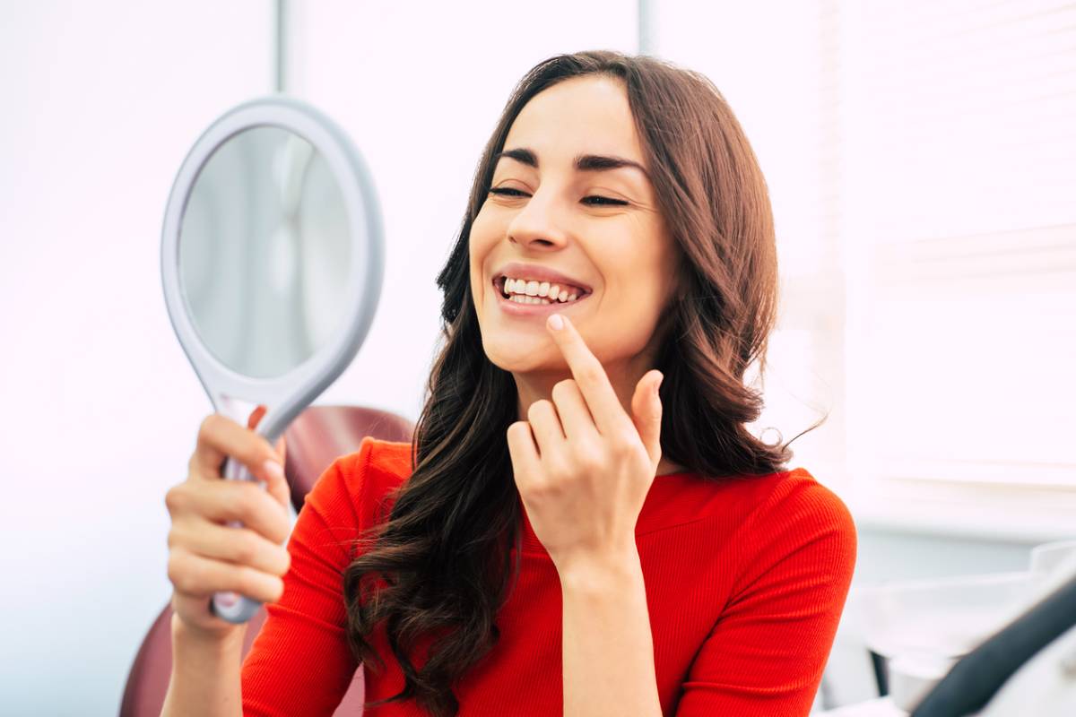 woman smiling learning ways to prolong teeth whitening results